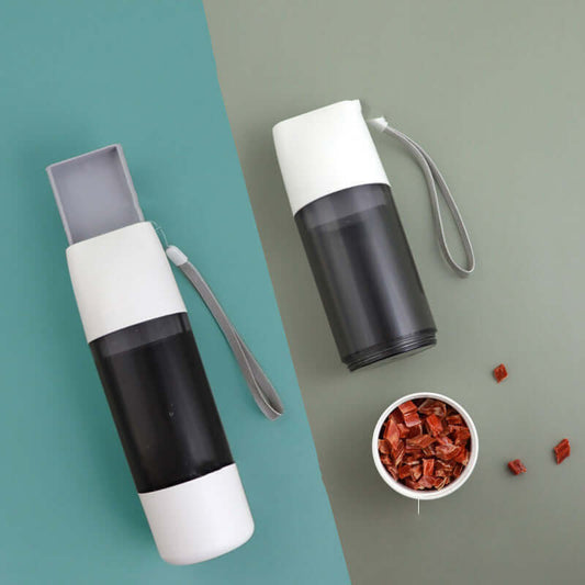PELOSETTINSHOP Portable Dog Water Bottle 350ml in black and white colors with treats on the side.