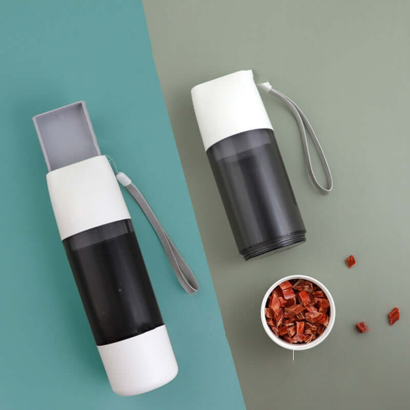 PELOSETTINSHOP Portable Dog Water Bottle 350ml in black and white colors with treats on the side.